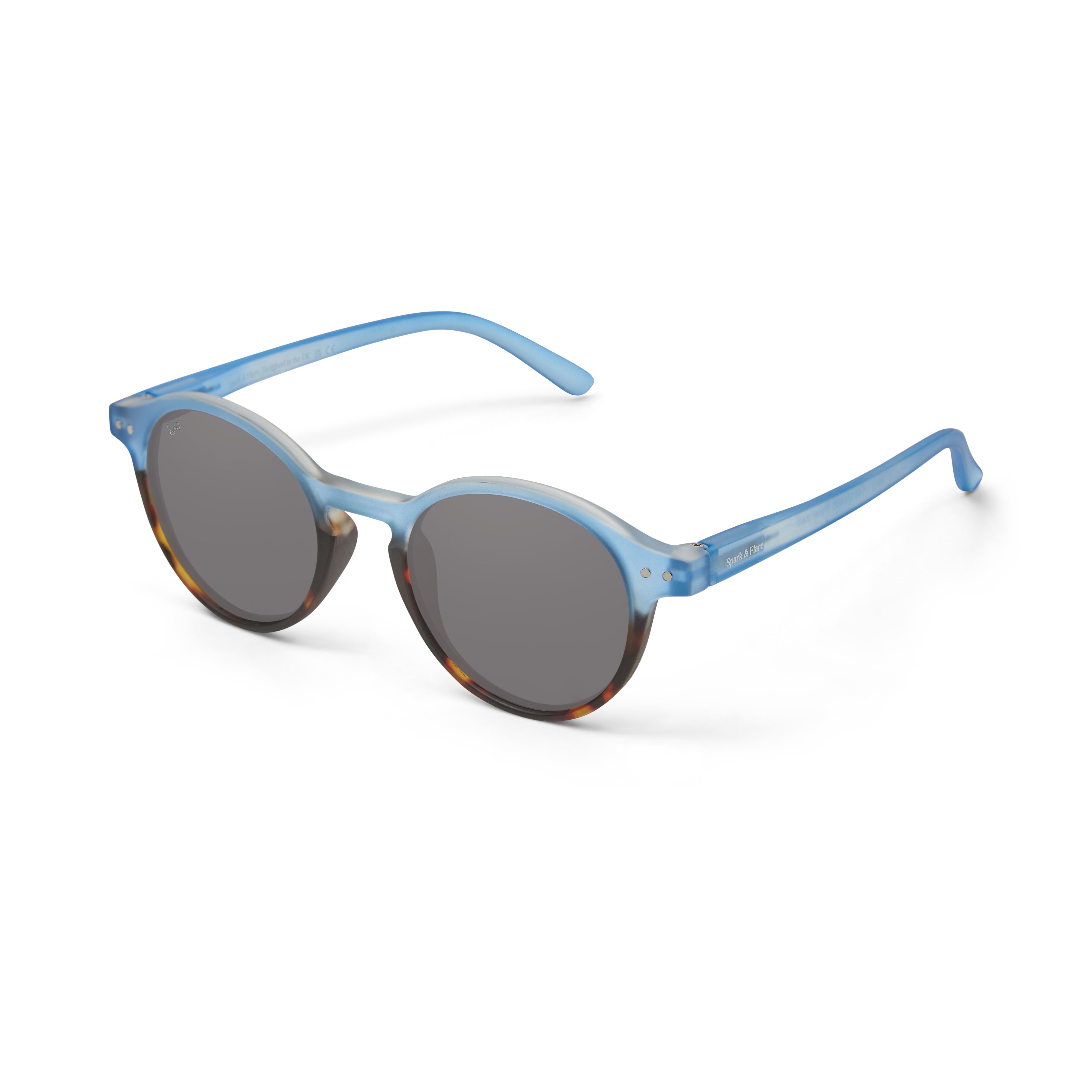 Spark & Flare sunglasses with a light blue and brown tortoise shell frame and grey polarized lenses
