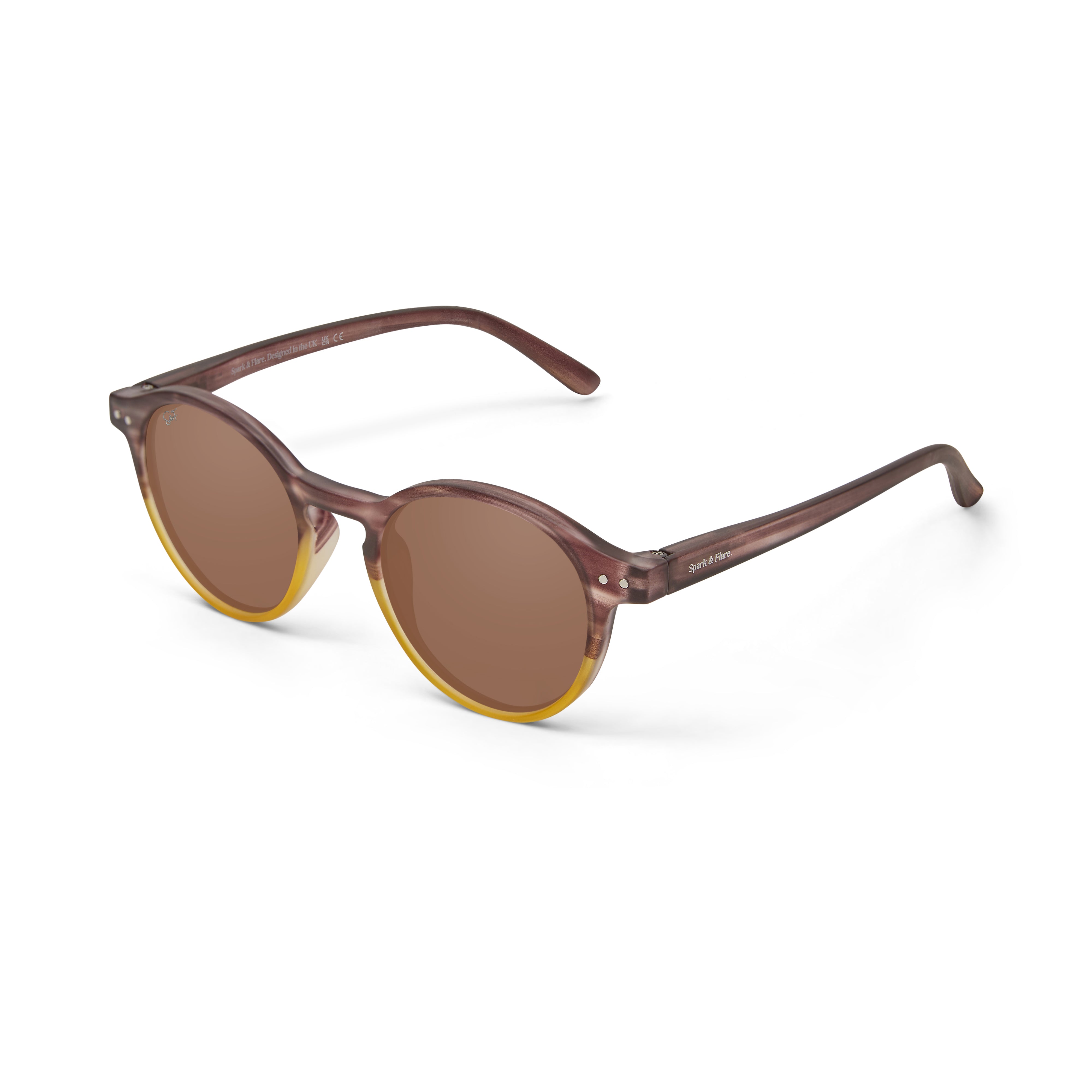 Round sunglasses with translucent brown acetate frames, warm brown lenses, and a yellow rim accent, shown on a clean white background.