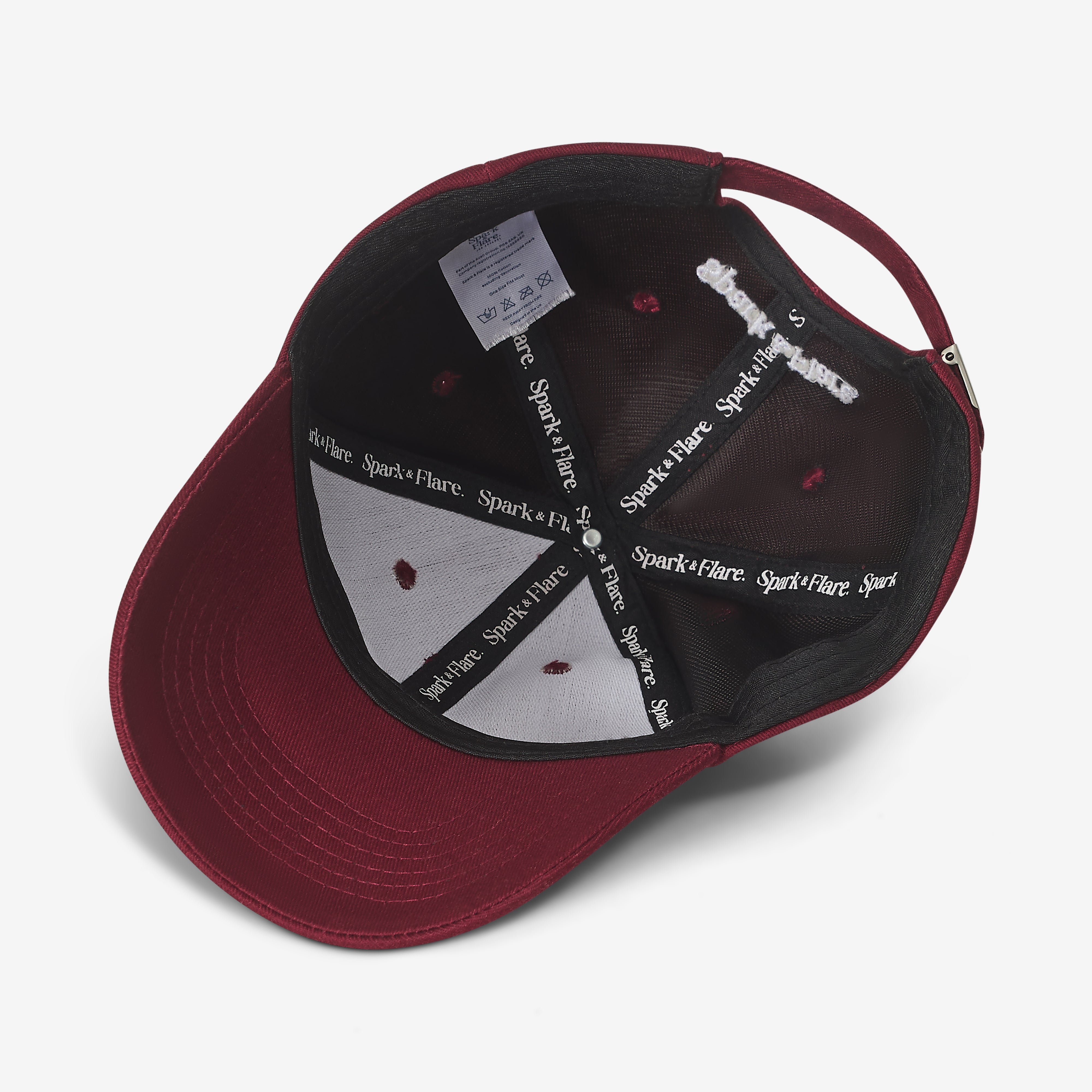 Inside of a Spark & Flare burgundy cap with branded lining