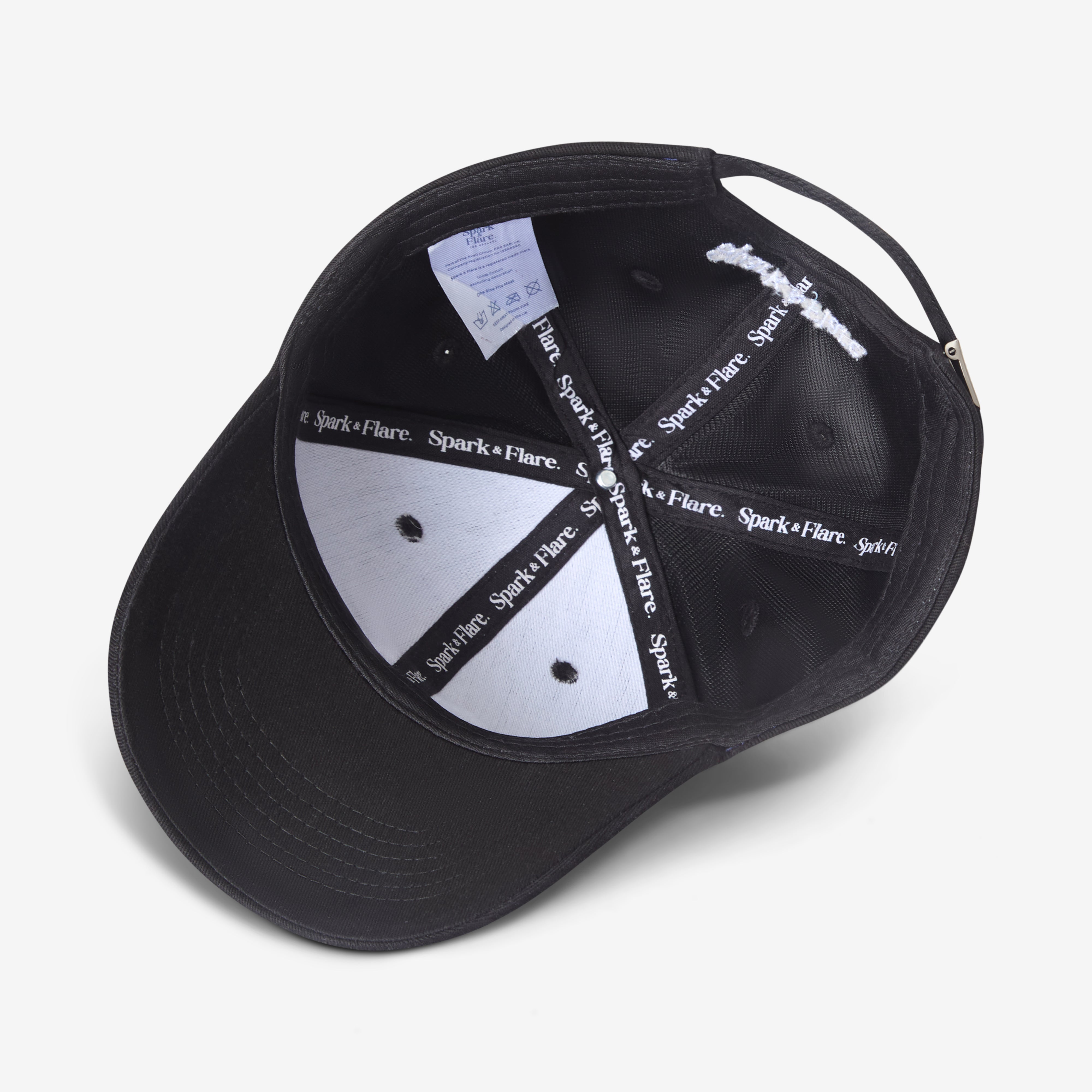 Inside of a black Spark & Flare Brave baseball cap with branded lining