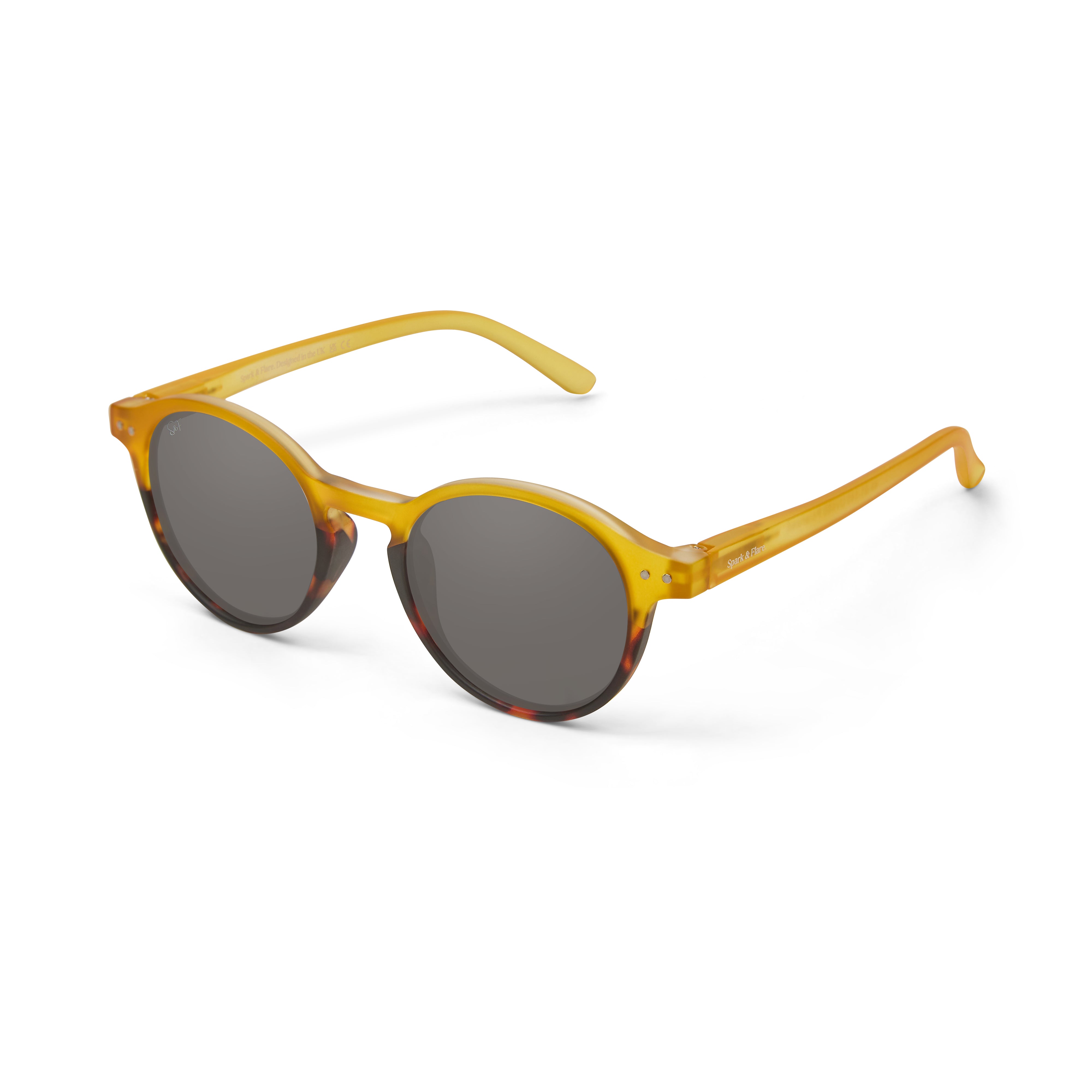 Round sunglasses with a translucent yellow acetate frame, dark grey lenses, and a tortoiseshell pattern on the lower frame edges, shown against a plain white background.